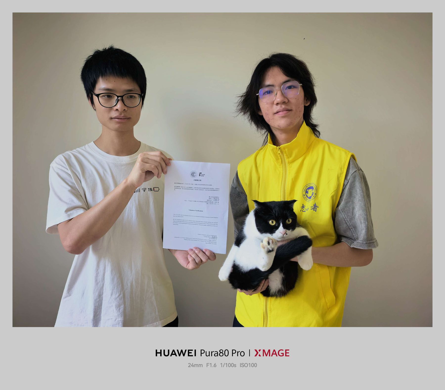 Holding a volunteer certificate with a cat